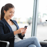 a woman sitting in a chair looking at her phone