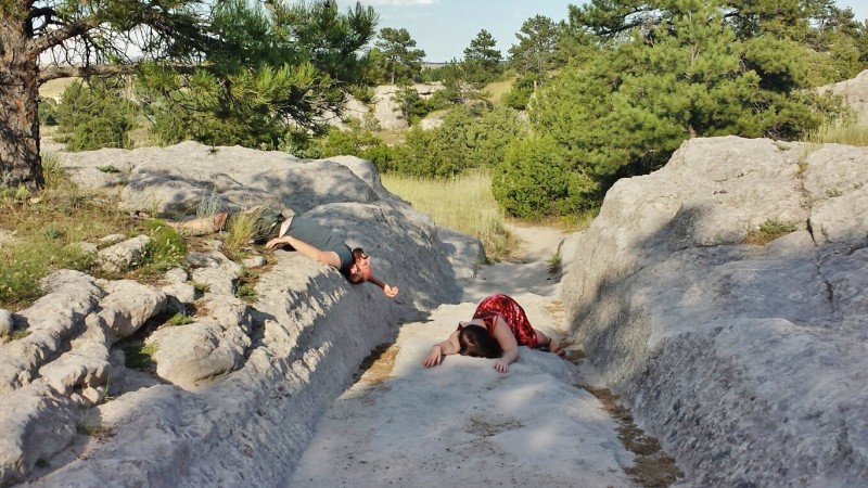 a man lying on a rock