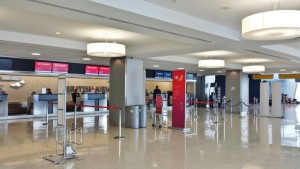 a large airport terminal with red and white signs