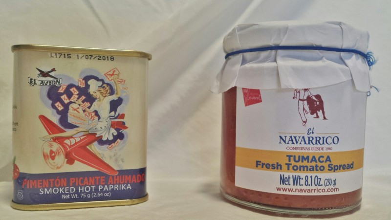 a can of canned food next to a jar of tomato sauce