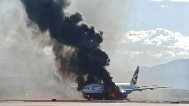 a plane on fire with black smoke coming out of it