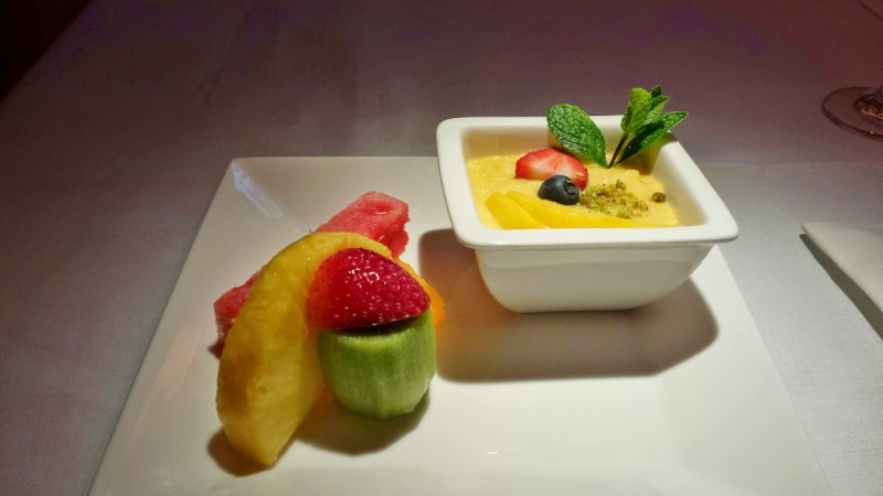 a bowl of fruit and a dessert on a plate