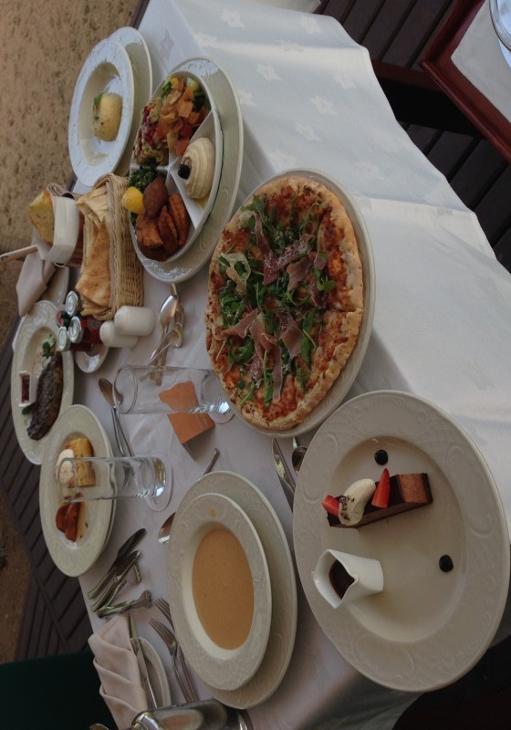 a table with plates of food and pizza