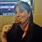 a woman eating a chicken leg