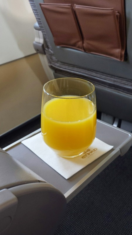Etihad Business Class AUH MAA orange juice welcome drink