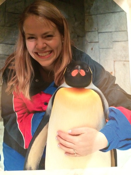 a woman holding a penguin
