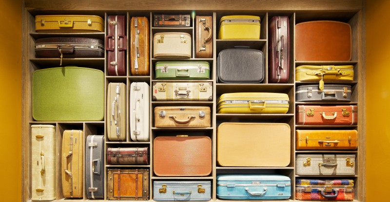 a shelf full of suitcases