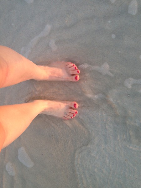a person's feet on sand