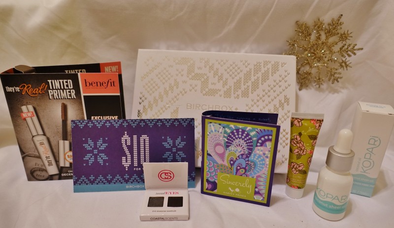a group of gift boxes and a tube of cream