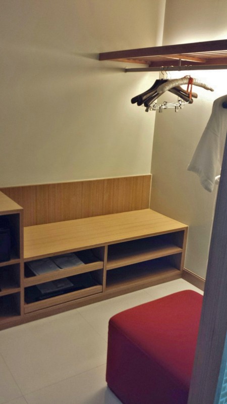 a closet with a bench and swingers