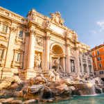 a large stone building with a fountain and statues with Trevi Fountain in the background