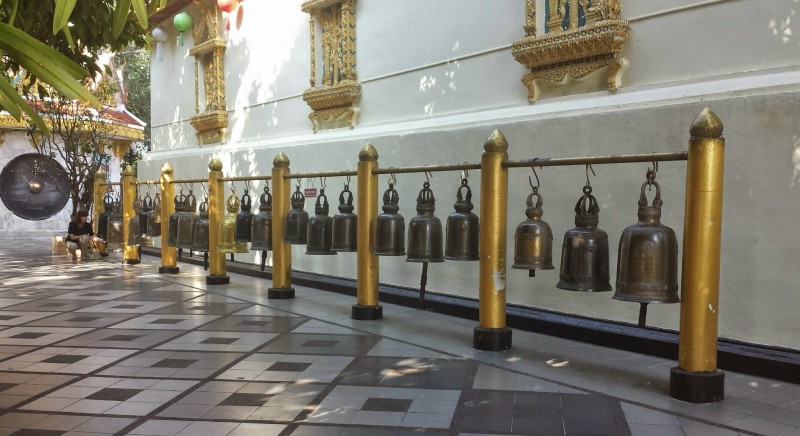 a row of bells on a railing