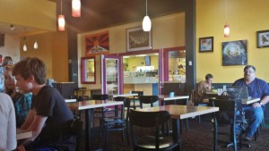 a group of people sitting at tables in a restaurant