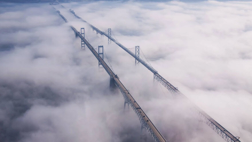 a bridge with clouds in the sky