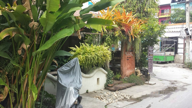 a building with plants and a sign