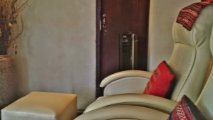 a white chair with red pillow in a room