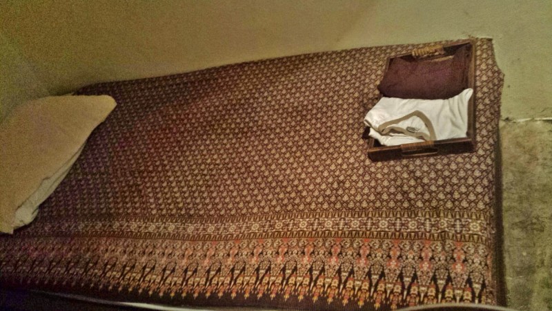 a bed with a tray and a pillow