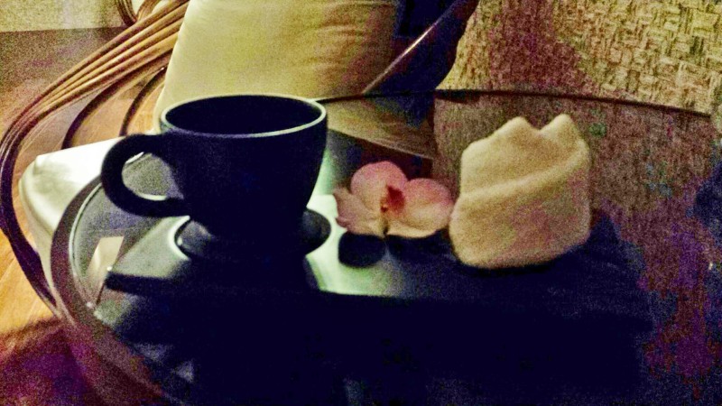 a cup and a towel on a table