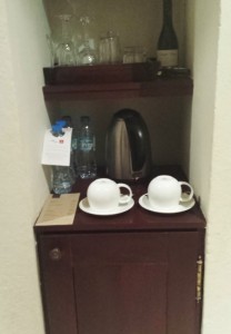 a cabinet with cups and saucers on it