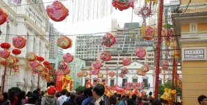 a crowd of people in a street with lanterns