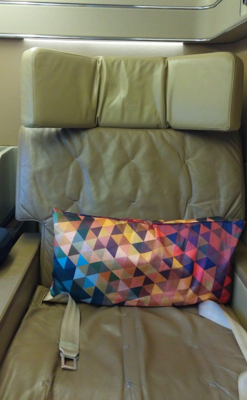 a colorful pillow on a chair