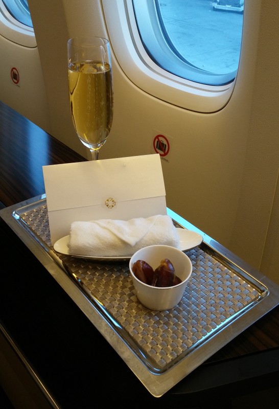 a tray with food and a glass of champagne