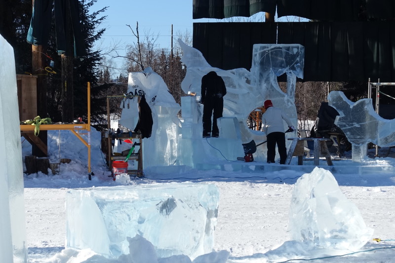 people working on an ice sculpture
