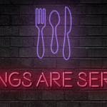 a neon sign with a fork spoon and knife