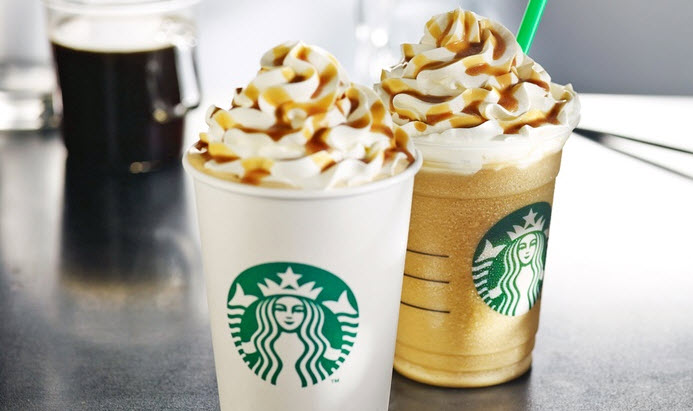 two cups of coffee with whipped cream and caramel toppings