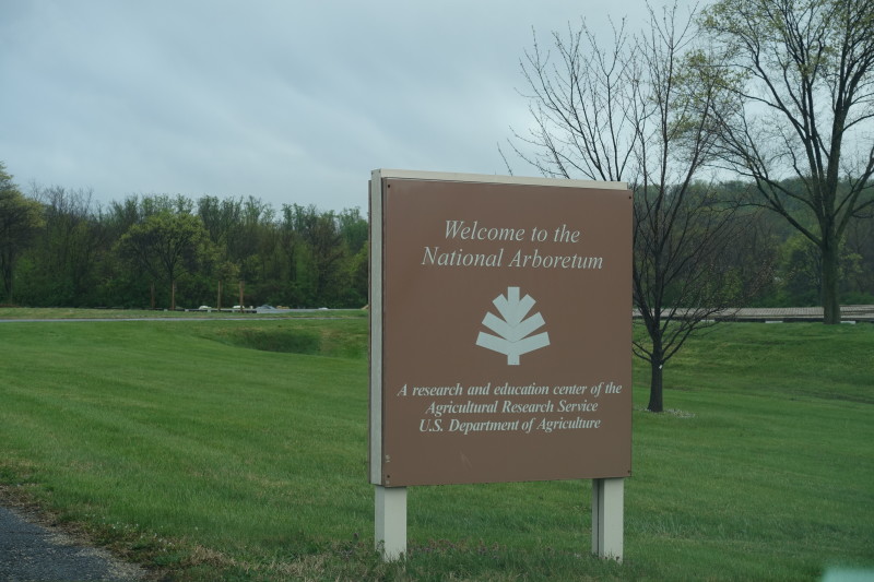 a sign in a grassy field