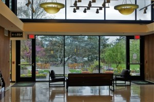a room with a large glass wall and chairs
