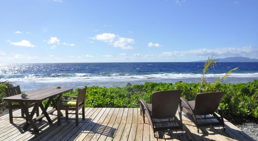 a deck with chairs and a view of the ocean