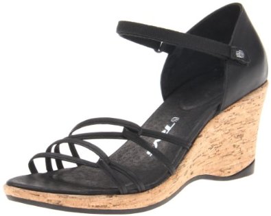 a black wedge sandal with a wooden heel