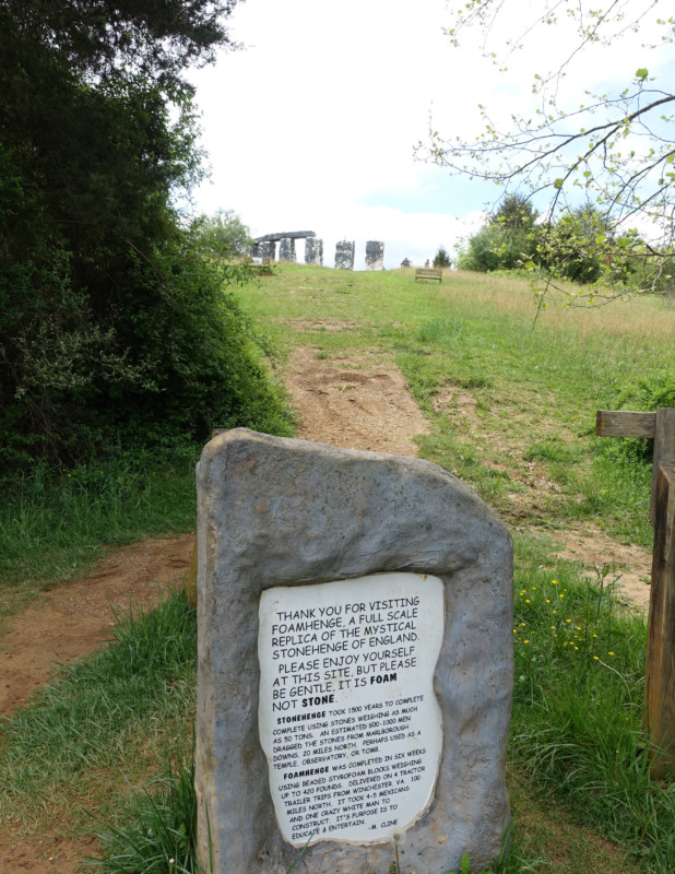 a stone sign in a grassy area