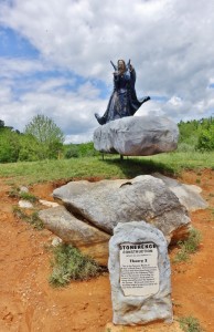 a statue of a woman on a rock