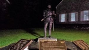 a statue of a man holding a rifle