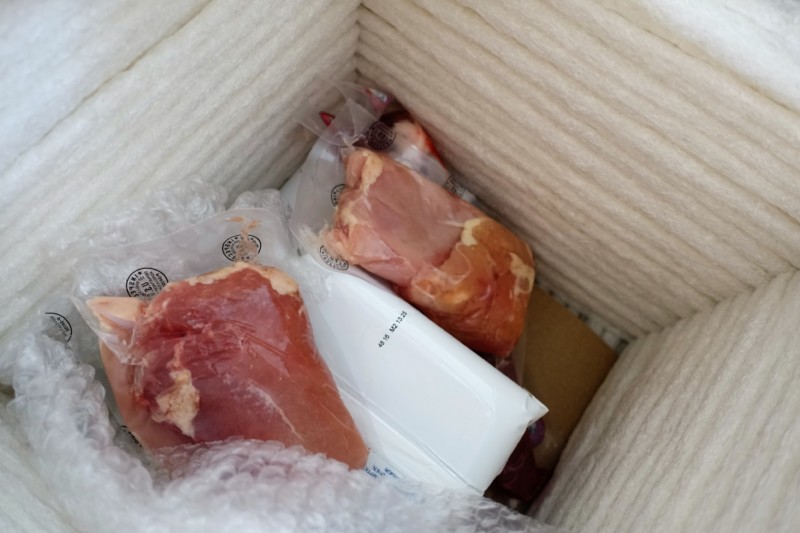 a box of meat in plastic wrap