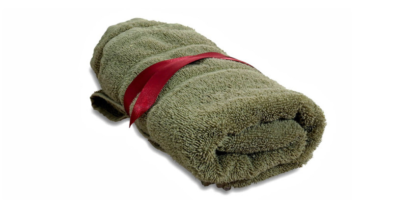 a green towel with a red ribbon