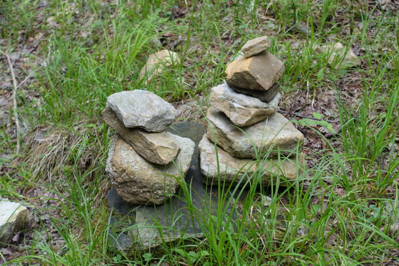 a stack of rocks in the grass