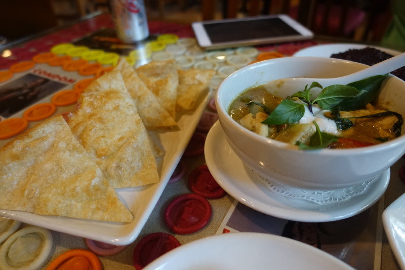 a bowl of soup and chips on a plate
