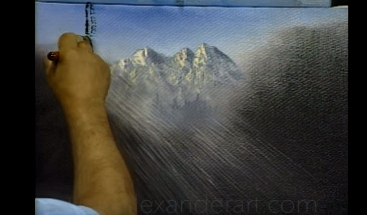 a person painting a picture of mountains