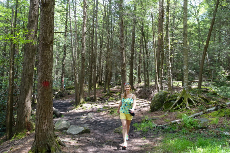 a woman walking in a forest