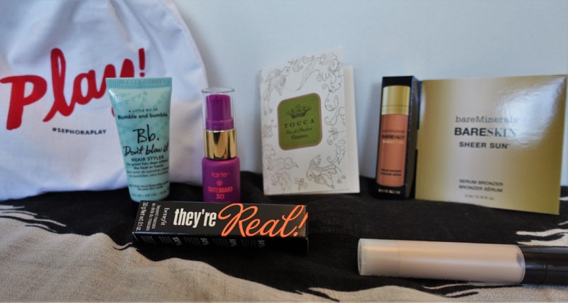 a group of makeup products on a bed