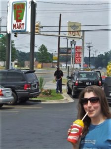 a woman drinking a beverage from a straw