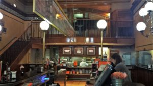 a woman sitting at a counter in a restaurant