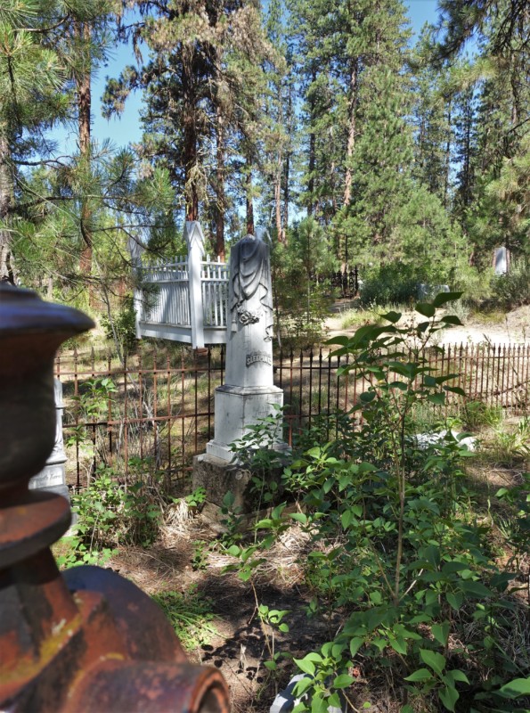 a white statue in a cemetery