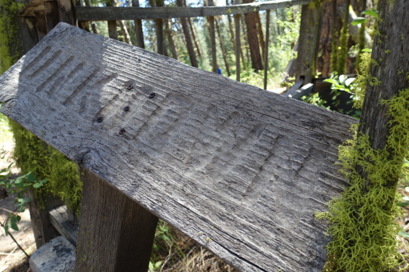 a wood plank with a fence in the background