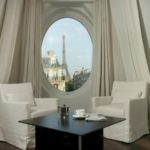 a room with a round window and a table