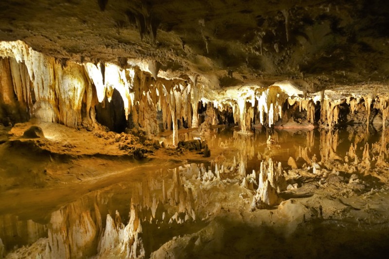 a cave with stalactites and water