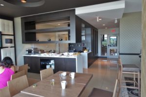 a room with a kitchen and dining area
